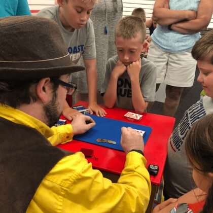 Wayne teaching magic to a group of kids at G.Wiliker's Toystore in Portsmouth, NH.