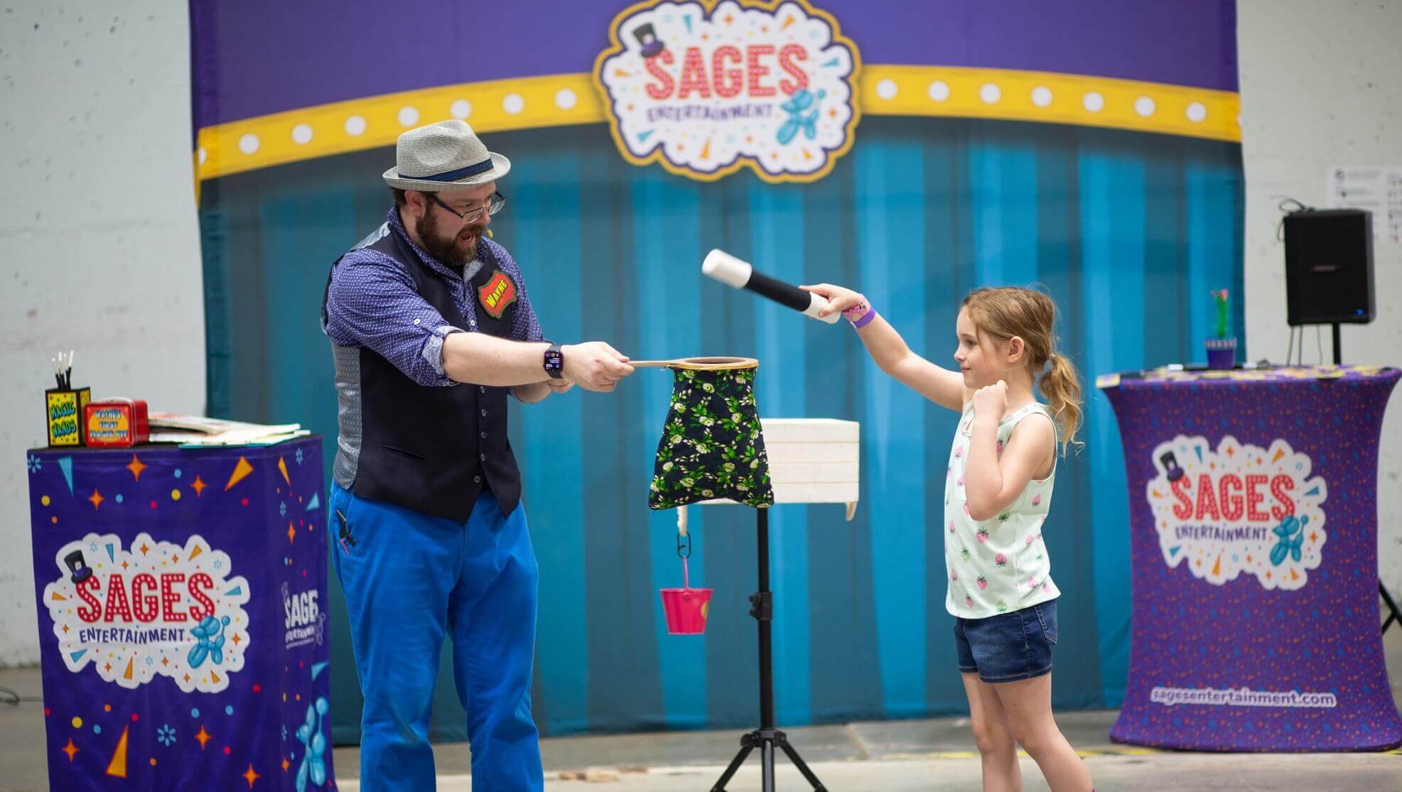 Wayne entertains at an outdoor library magic show.